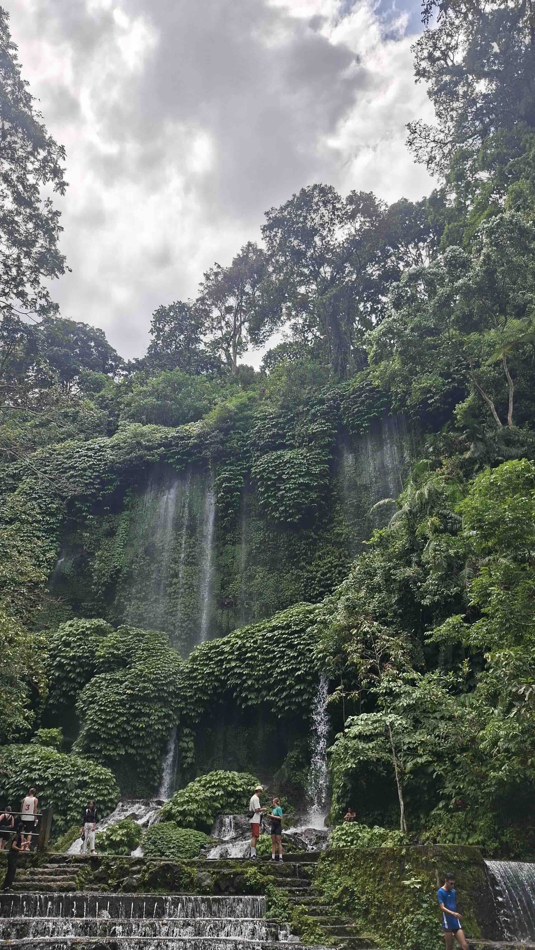 Visitors on a viewing platform at Tetebatu's tiered waterfall system